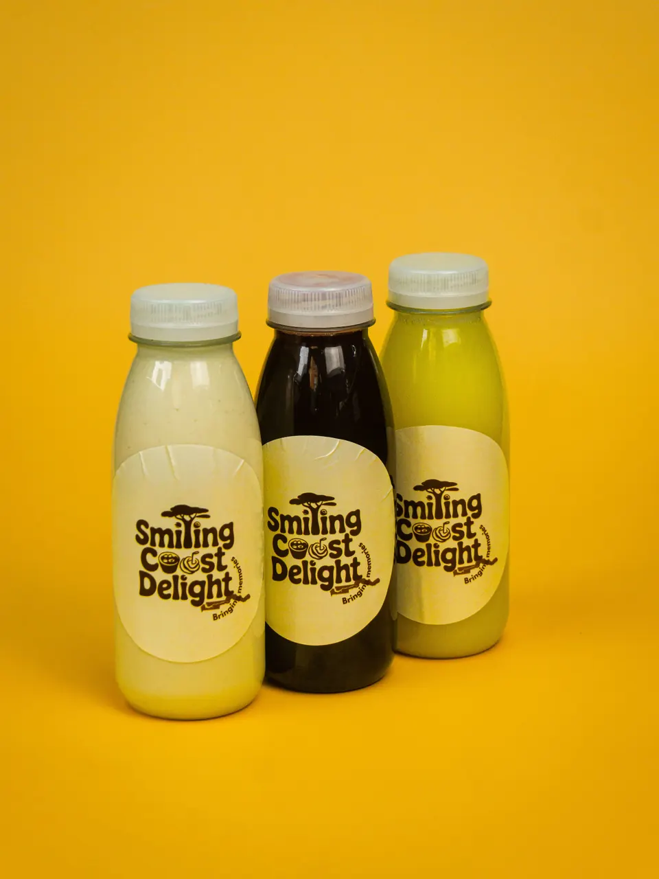 Three bottled Smiling Coast Delight drinks side by side